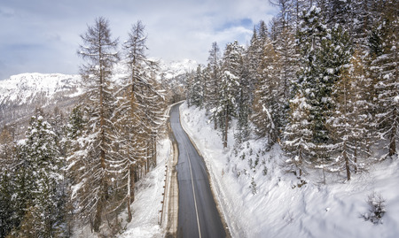 Curved asphalt road in high Alps mountains, winter seasonの写真素材