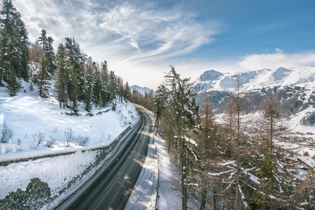 Asphalt curved road in high Alp mountains, winter seasonの写真素材
