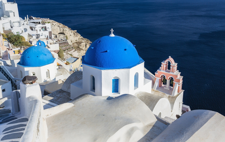 Blue dome traditional church on the cliff in Oia, Santorini Island, Greeceの写真素材