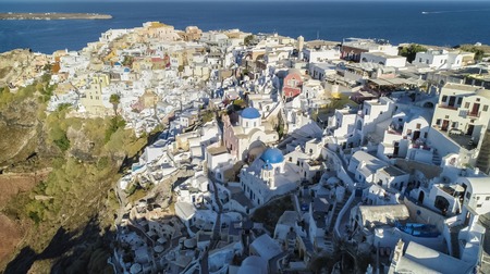 Aerial view of white houses on the cliff in Oia, Santorini Island, Greece