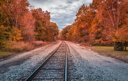 Railway track with a curve and trees in autumn colors, United Statesの写真素材