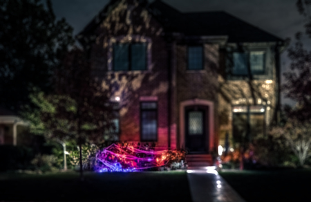 Seasonal Halloween House Lights Decoration at night, outdoor blurred defocused viewの写真素材