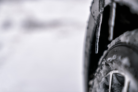Close up of the car tire with icicles, winterの写真素材