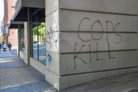 CHICAGO, ILLINOIS - MAY 31, 2019: Store fronts damaged and full of graffiti after demonstrations against police in Chicagoのeditorial素材
