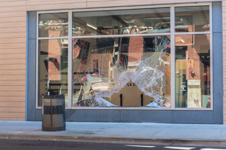 CHICAGO, ILLINOIS - MAY 31, 2019: Broken window storefront after protesters march demonstrations...