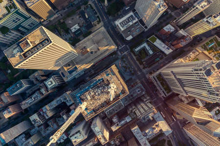 Top down aerial view of Chicago Downtown skyscrapers with antennas. Urban grid with streets and tall...