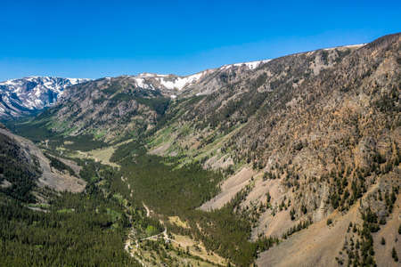 Aerial view of valley in high Montana mountains near iconic town Red Loge. Snow on the peak tops.の写真素材