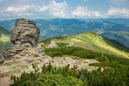 Rock Mountains against Cloudy Blue Sky on Backgroundの写真素材
