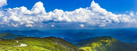 Carpathians in summer day. Mountains against the sunny blue sky with clouds on background