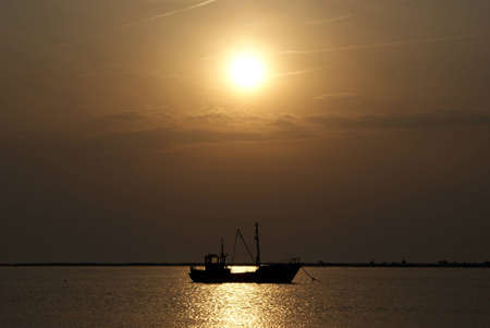 silhouette of boat at sunsetの写真素材