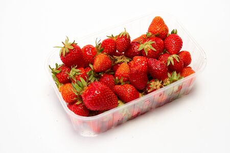 Tray of ripe red strawberries on a white backgroundの写真素材