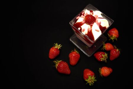Strawberry dessert with strawberries on a black background, top viewの写真素材