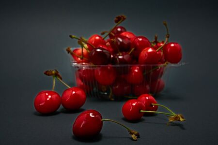 Tray with fresh cherry on a gray backgroundの写真素材