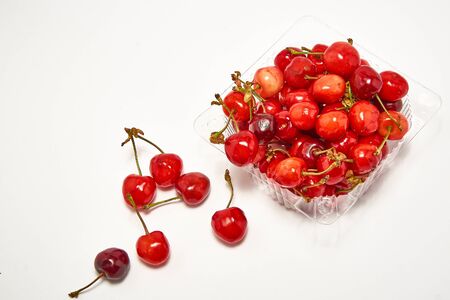 Container with fresh cherry on a white backgroundの写真素材