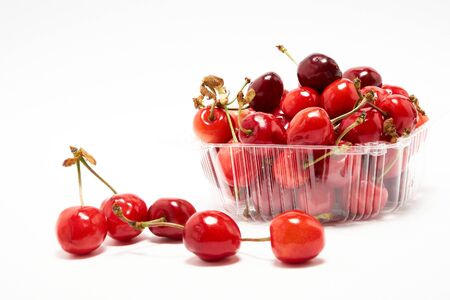Container with fresh cherry on a white backgroundの写真素材