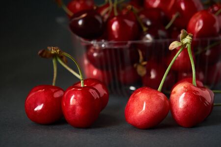 Tray with fresh cherry on a gray backgroundの写真素材