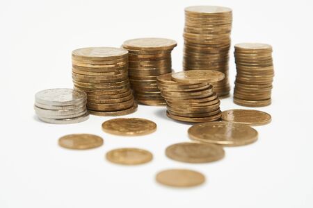 Stacks of coins on a white backgroundの写真素材