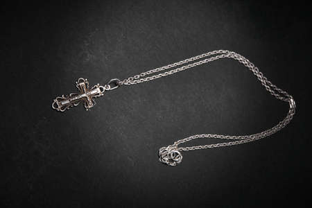 Cross with chain on a dark backgroundの写真素材