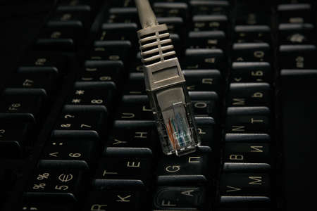 Network cable on keyboard, internet, worldwide networkの写真素材