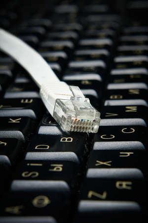 Network cable on keyboard, internet, worldwide networkの写真素材