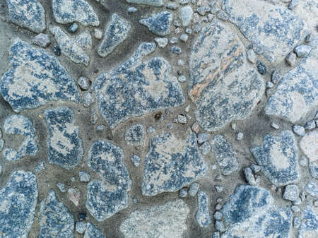 Piece of road paved with old cobblestones, abstract background, top view.の写真素材