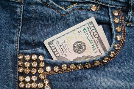 Dollar bill in the front pocket of blue jeans. Money in your pocket, cash