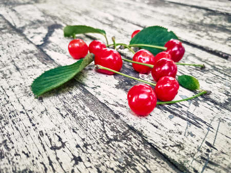Fresh ripe red cherries on wood background.の写真素材