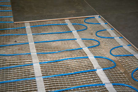 Laying an electric mat under the tiles. Warm floor. Heating floorの写真素材