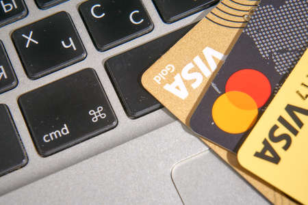 Ukraine - March 2022: Bank plastic cards lie on the computer keyboard.
