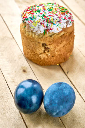 Pasca and blue painted eggs on a wooden background, vertical shot, vertical orientation.の写真素材