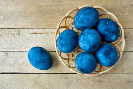 Blue painted eggs on a wooden background.の写真素材