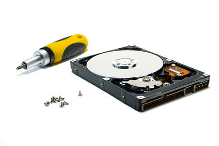 Open hard drive and screwdriver isolated on white background closeup. Computer hard drive HDD....