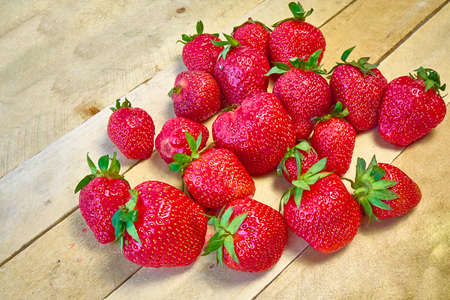 Fresh ripe organic strawberries on a wooden background.の写真素材