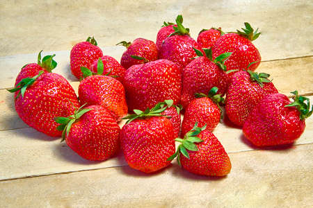 Fresh ripe organic strawberries on a wooden background.の写真素材