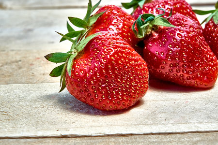 Fresh ripe organic strawberries on a wooden background.の写真素材