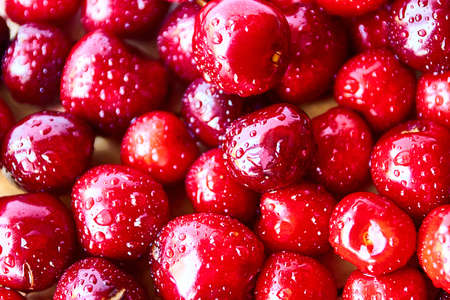 Group of fresh ripe red cherries on wooden background, top view.の写真素材