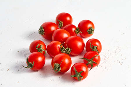 Cherry tomato group, ripe organic tomatoes on a light backgroundの写真素材