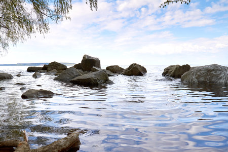 Stones in the water, large stones are washed by the water, seascapeの写真素材