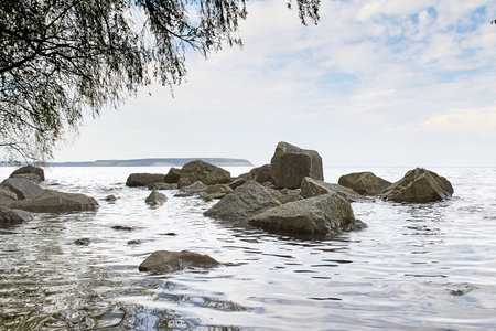 Stones in the water, large stones are washed by the water, seascapeの写真素材