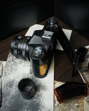 Old vintage camera with back cover open for close up film replacement, rolls of film, old photos, oblique view, floating focus, fine grain filmの写真素材