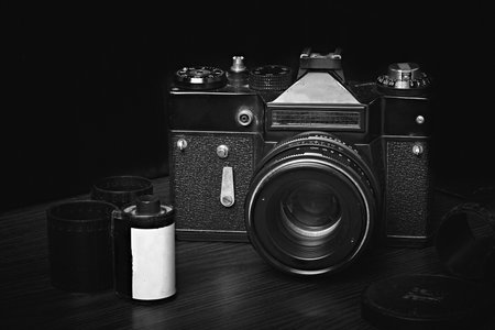 Old film rangefinder SLR camera, film reels, developed film, black and white photography