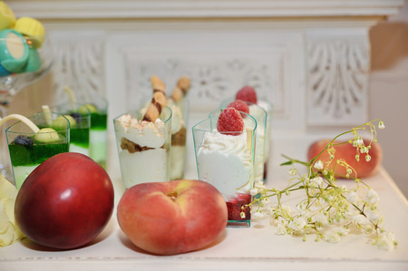 delicious food, cakes and fruits on the tableの写真素材