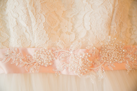 Wedding ceremony accessories. Bride dress close up detailsの写真素材