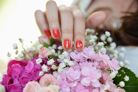 Wedding accessories. Bride flower bouquet isolated and hand details. I do message written on nailsの写真素材