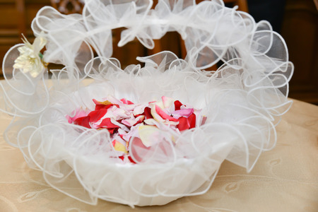 Rose petals inside bride wedding basketの写真素材