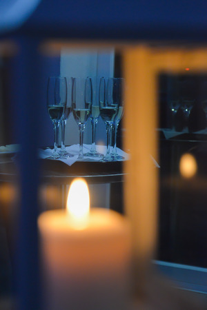Candle light and champagne glasses. Restaurant wedding ceremony arrangements