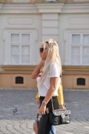 TIMISOARA, ROMANIA - April 18, 2018, Piata Unirii square: two beautiful blonde are walking on the street. Real peopleのeditorial素材