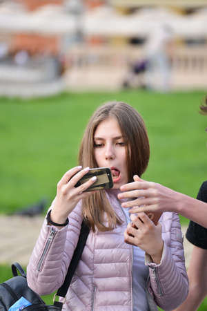 TIMISOARA, ROMANIA - April 18, 2018, Piata Unirii square: young girl is making a selfie photograph on the streetのeditorial素材
