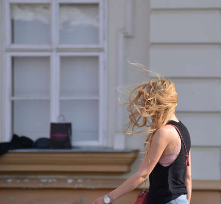 TIMISOARA, ROMANIA - March 15, 2018, Piata Unirii square: blonde girl dressed in black is walking on the streetのeditorial素材