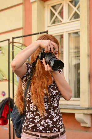 TIMISOARA, ROMANIA - April 27, 2013: portrait of a redhead woman photographerのeditorial素材